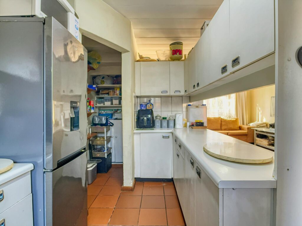 Bright kitchen in Pretoria featuring sleek countertops and a well-stocked pantry. Ideal for culinary enthusiasts.