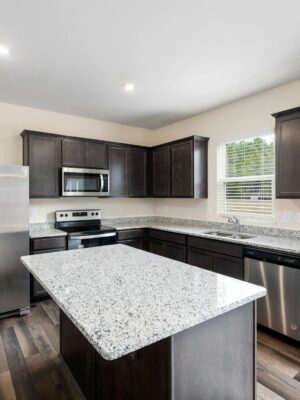 Luxurious modern kitchen featuring granite countertops and stainless steel appliances.